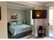 Cozy bedroom features a queen-sized bed, a wall-mounted TV, and access to the balcony at 260 E Flamingo Rd # 228, Las Vegas, NV 89169