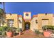 Beautiful building entrance with landscaped grounds, arches, and terracotta pots at 260 E Flamingo Rd # 228, Las Vegas, NV 89169