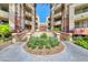 Stunning entrance to a community, landscaped with vibrant plants and palm trees at 260 E Flamingo Rd # 228, Las Vegas, NV 89169