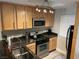 Efficient kitchen with stainless steel appliances, wood cabinetry, and granite countertops at 260 E Flamingo Rd # 228, Las Vegas, NV 89169