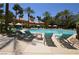 Stunning community pool surrounded by plenty of lounge seating and palm trees in a resort-style setting at 260 E Flamingo Rd # 228, Las Vegas, NV 89169