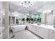 Spa-like bathroom with soaking tub, double vanity, and elegant chandelier lighting at 2747 Paradise Rd # 206, Las Vegas, NV 89109