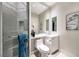 This bathroom features white cabinets, a toilet, and a shower with a built-in seat at 2747 Paradise Rd # 206, Las Vegas, NV 89109