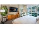 This bedroom features a work area and a large window view of tropical palm trees at 2747 Paradise Rd # 206, Las Vegas, NV 89109