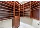 Spacious walk-in closet with custom wood shelving and drawers for optimal storage at 2747 Paradise Rd # 206, Las Vegas, NV 89109