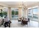Bright dining area with large windows and a stylish chandelier, perfect for enjoying meals with a view at 2747 Paradise Rd # 206, Las Vegas, NV 89109