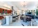 Modern kitchen with a large island, stainless steel appliances, and seating, flowing into a dining and living area at 2747 Paradise Rd # 206, Las Vegas, NV 89109