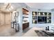 Living room featuring built-in shelving, a beverage area, and modern decor, creating a cozy and stylish space at 2747 Paradise Rd # 206, Las Vegas, NV 89109