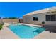 Sparkling pool and spa in the backyard with lush landscaping, privacy wall, and outdoor seating at 2848 Skowhegan Dr, Henderson, NV 89074
