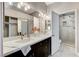 Bathroom features a double sink vanity, modern lighting, and a tiled shower at 2848 Skowhegan Dr, Henderson, NV 89074