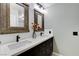 Bathroom featuring double sinks with dark wood cabinets and modern fixtures at 2848 Skowhegan Dr, Henderson, NV 89074