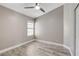 Bedroom with wood-look flooring, white trim, a window, and a ceiling fan at 2848 Skowhegan Dr, Henderson, NV 89074