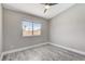 Bright bedroom with wood-look floors, natural light and neutral wall color at 2848 Skowhegan Dr, Henderson, NV 89074