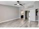 Bedroom with wood-look flooring, ceiling fan, and access to the bathroom with dual sinks at 2848 Skowhegan Dr, Henderson, NV 89074