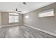 Neutral bedroom with wood-look flooring, a ceiling fan, and large window at 2848 Skowhegan Dr, Henderson, NV 89074