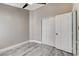 Bedroom with wood-look flooring, base molding, and a sliding-door closet at 2848 Skowhegan Dr, Henderson, NV 89074