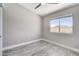 Well-lit bedroom with gray wood floors, natural light and ceiling fan at 2848 Skowhegan Dr, Henderson, NV 89074