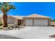 Charming single-story home featuring a two-car garage, desert landscaping, and a beautiful palm tree at 2848 Skowhegan Dr, Henderson, NV 89074