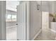 Hallway view showcasing neutral decor, tiled floors and open doorway to a bedroom at 2848 Skowhegan Dr, Henderson, NV 89074