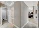 Hallway with neutral walls and tile flooring leads to the kitchen and other rooms at 2848 Skowhegan Dr, Henderson, NV 89074