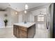 Spacious kitchen featuring an island with seating and an open view to the living area at 2848 Skowhegan Dr, Henderson, NV 89074