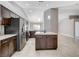 Bright kitchen with granite countertops, stainless steel appliances, and dark wood cabinetry at 2848 Skowhegan Dr, Henderson, NV 89074