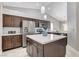Bright kitchen featuring stainless steel appliances, dark wood cabinets and a center island at 2848 Skowhegan Dr, Henderson, NV 89074