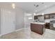 Open concept kitchen with stainless steel appliances and a center island perfect for entertaining at 2848 Skowhegan Dr, Henderson, NV 89074