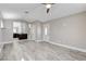 Living room with wood-look flooring, ceiling fan, and open access to the kitchen at 2848 Skowhegan Dr, Henderson, NV 89074