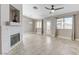 Living room with tiled flooring, white fireplace, and lots of natural light from the windows at 2848 Skowhegan Dr, Henderson, NV 89074