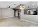 Open-concept living area featuring tiled floors, modern lighting and access to the kitchen at 2848 Skowhegan Dr, Henderson, NV 89074