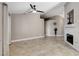Spacious living room with tiled flooring, a ceiling fan, and a decorative fireplace at 2848 Skowhegan Dr, Henderson, NV 89074