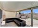 Covered patio with comfortable seating and outdoor kitchen with a built-in grill at 2848 Skowhegan Dr, Henderson, NV 89074