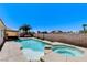 An inviting backyard features a sparkling pool and spa combo with lush landscaping at 2848 Skowhegan Dr, Henderson, NV 89074