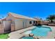 A backyard features a sparkling pool and spa combo, BBQ, and mature trees at 2848 Skowhegan Dr, Henderson, NV 89074