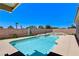 An inviting backyard features a sparkling pool and spa combo with block fencing at 2848 Skowhegan Dr, Henderson, NV 89074
