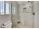 Tiled shower with a glass enclosure, bench, and a pebble-accented niche at 2848 Skowhegan Dr, Henderson, NV 89074