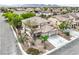 Aerial view of a two-story home featuring a tile roof and three-car garage at 3065 Blue Monaco St, Las Vegas, NV 89117