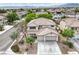 Aerial view of a two-story home featuring a tile roof and three-car garage at 3065 Blue Monaco St, Las Vegas, NV 89117