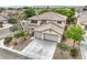 Aerial view of a two-story home featuring a tile roof and three-car garage at 3065 Blue Monaco St, Las Vegas, NV 89117