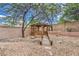 A backyard featuring decorative rock, a wooden gazebo, and a small foot bridge at 3065 Blue Monaco St, Las Vegas, NV 89117