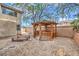 A backyard featuring decorative rock, a wooden gazebo, and a small foot bridge at 3065 Blue Monaco St, Las Vegas, NV 89117