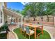 An inviting backyard featuring a patio area, dining table and lush landscaping perfect for outdoor entertaining at 3065 Blue Monaco St, Las Vegas, NV 89117