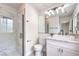 Bathroom featuring white vanity, marble countertop, modern lighting, glass enclosed shower with stylish tile at 3065 Blue Monaco St, Las Vegas, NV 89117
