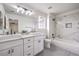 Modern bathroom showcasing double sinks, marble countertops, and a combined shower-tub with stylish tile work at 3065 Blue Monaco St, Las Vegas, NV 89117