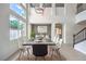 Bright dining room features soaring ceilings, chandelier, and natural light from large windows at 3065 Blue Monaco St, Las Vegas, NV 89117