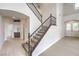 Elegant entryway featuring a staircase with decorative railings and arched doorways, creating a grand entrance at 3065 Blue Monaco St, Las Vegas, NV 89117