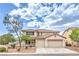 Charming two-story home featuring a tile roof, three-car garage and desert landscaping at 3065 Blue Monaco St, Las Vegas, NV 89117