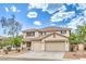 Charming two-story home featuring a tile roof, three-car garage and desert landscaping at 3065 Blue Monaco St, Las Vegas, NV 89117