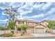 Charming two-story home featuring a tile roof, three-car garage and desert landscaping at 3065 Blue Monaco St, Las Vegas, NV 89117